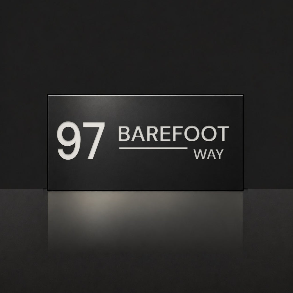 Matte black house number and street name sign, The Alexandra, reading 97 Barefoot Way in white lettering.
