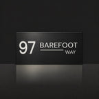Matte black house number and street name sign, The Alexandra, reading 97 Barefoot Way in white lettering.