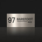 Brushed silver house number and street name sign with a brushed metal look, The Alexandra, reading 97 Barefoot Way in black lettering.