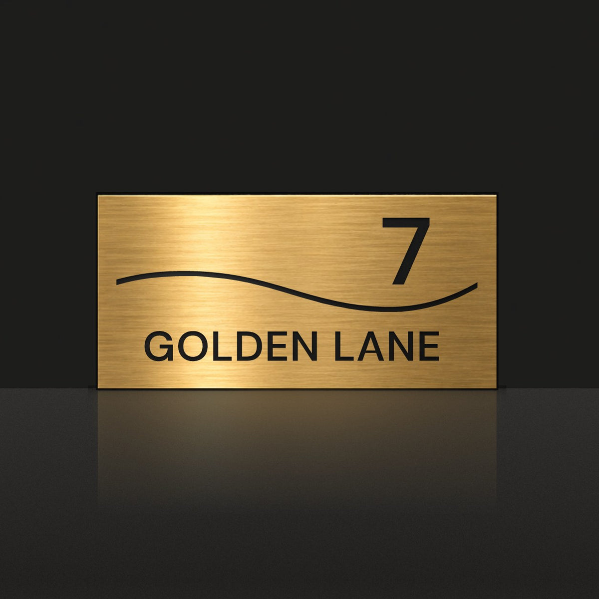Brushed gold house number and street name sign with a brushed metal look, The Bokarina, reading 7 Golden Lane in black lettering, with a wave line.