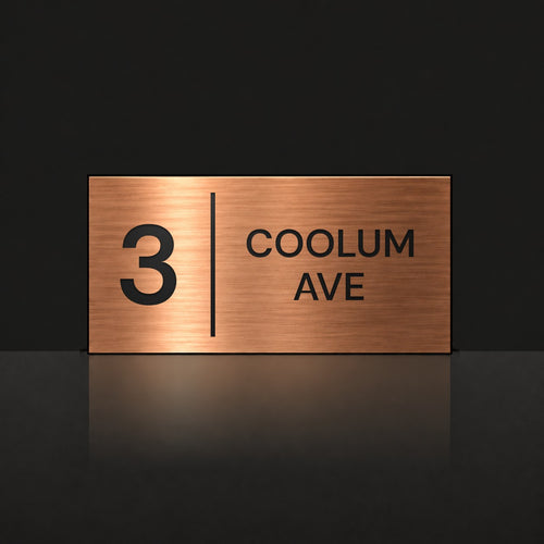 Brushed copper house number and street name sign with a brushed metal look, The Coolum, reading 3 Coolum Ave in black lettering, with a dividing line.