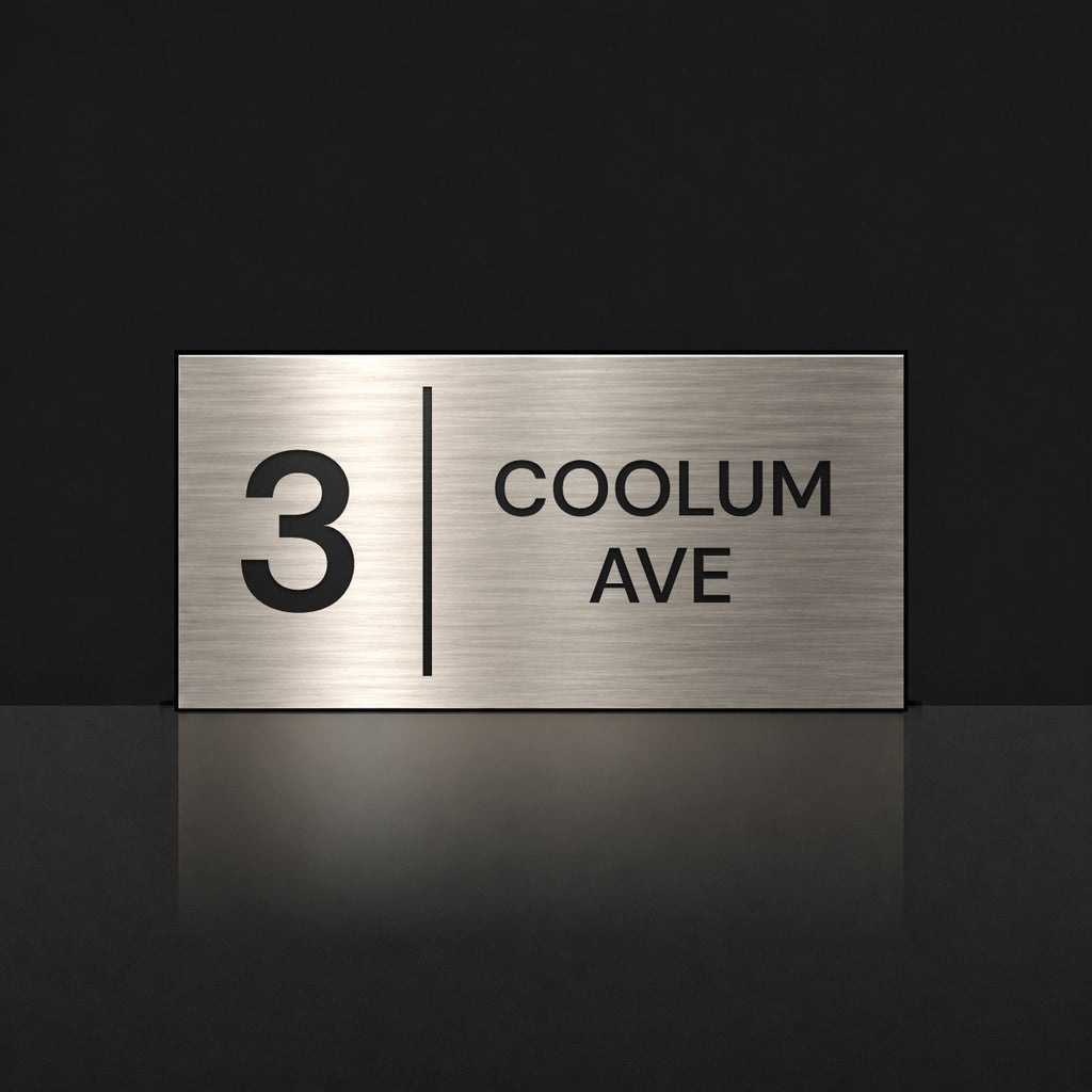 Brushed silver house number and street name sign with a brushed metal look, The Coolum, reading 3 Coolum Ave in black lettering, with a dividing line.