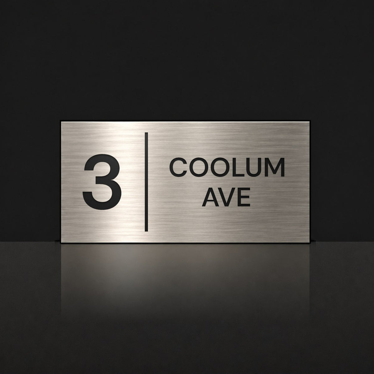 Brushed silver house number and street name sign with a brushed metal look, The Coolum, reading 3 Coolum Ave in black lettering, with a dividing line.