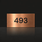 Brushed copper house number sign with a brushed metal look, The Kawana, with the number 493 in black lettering.