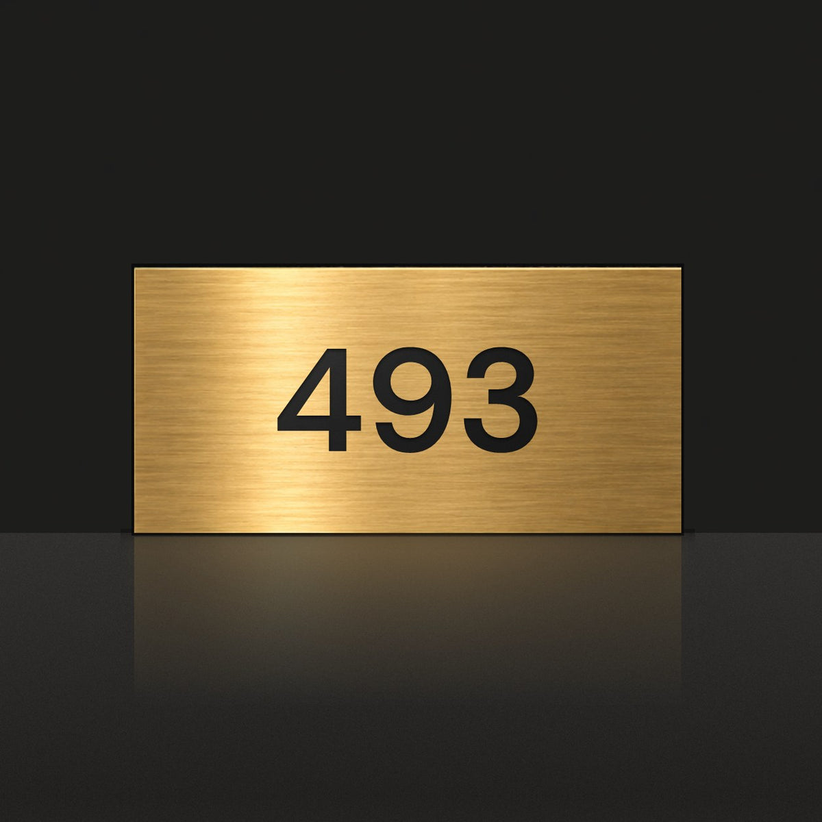 Brushed gold house number sign with a brushed metal look, The Kawana, with the number 493 in black lettering.