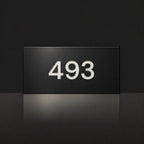 Matte black house number sign, The Kawana, with the number 493 in white lettering.