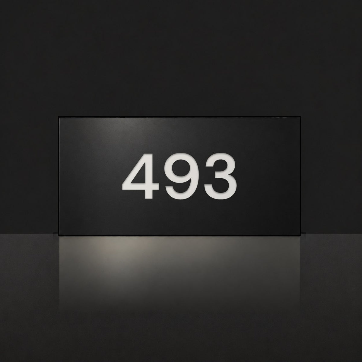 Matte black house number sign, The Kawana, with the number 493 in white lettering.