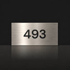 Brushed silver house number sign with a brushed metal look, The Kawana, with the number 493 in black lettering.