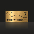 Brushed gold house number and street name sign with a brushed metal look, The Moffat, reading 7 Moffat Court in black lettering, with a wave.