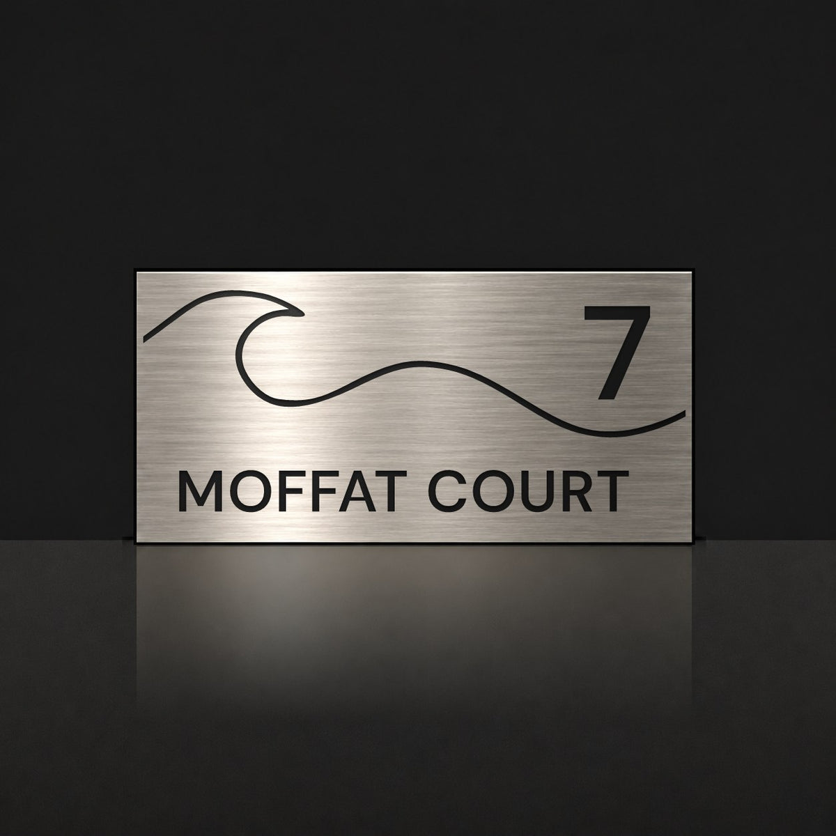 Brushed silver house number and street name sign with a brushed metal look, The Moffat, reading 7 Moffat Court in black lettering, with a wave.