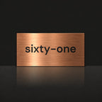 Brushed copper house number sign with a brushed metal look, The Montville, with the number spelled out as sixty-one in black lettering.
