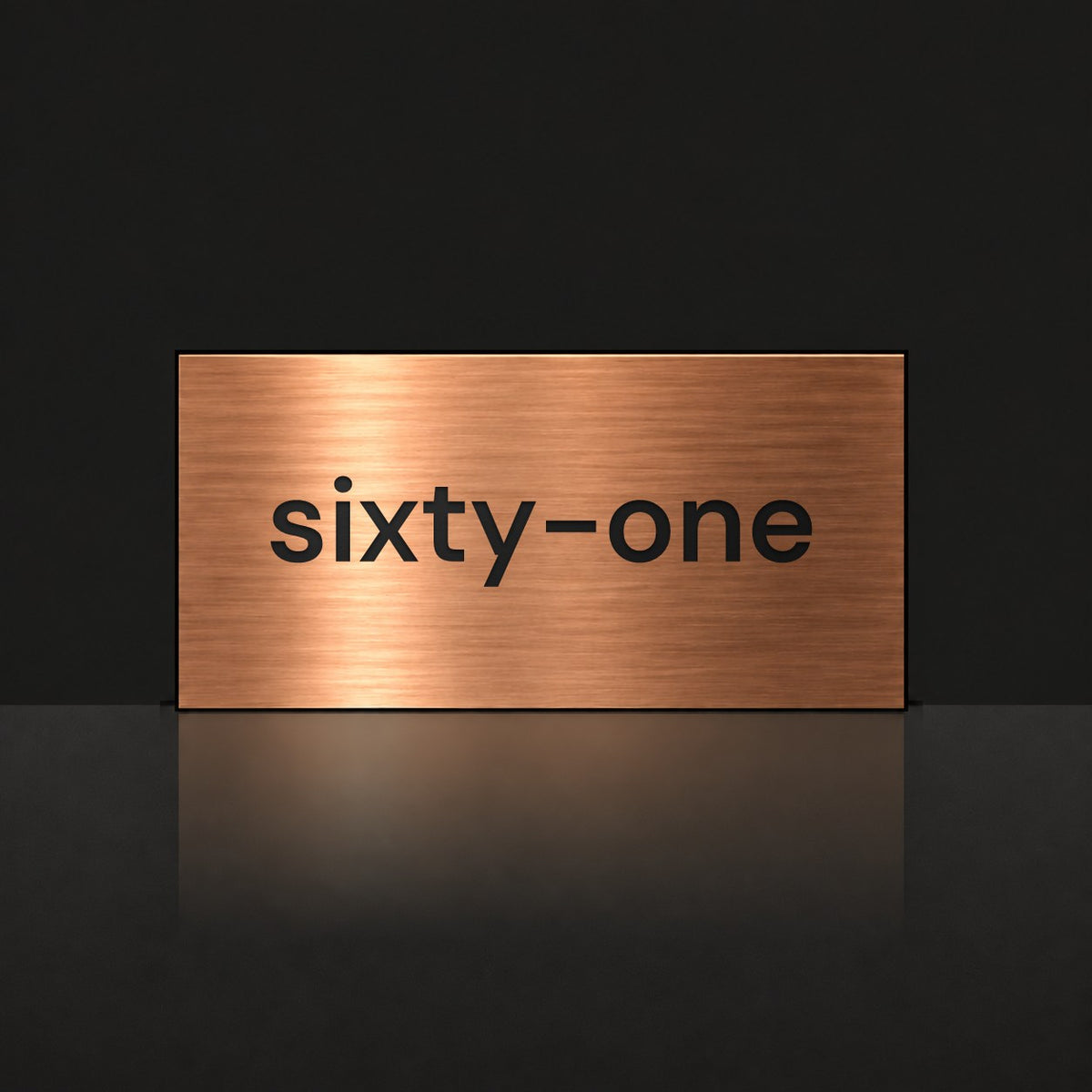 Brushed copper house number sign with a brushed metal look, The Montville, with the number spelled out as sixty-one in black lettering.
