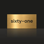 Brushed gold house number sign with a brushed metal look, The Montville, with the number spelled out as sixty-one in black lettering.