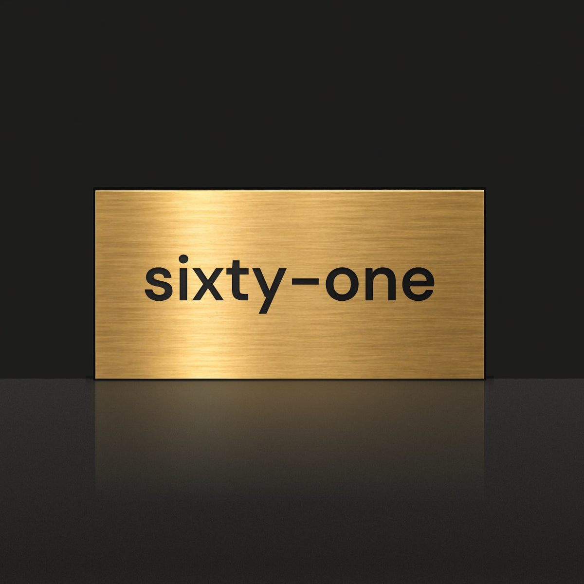 Brushed gold house number sign with a brushed metal look, The Montville, with the number spelled out as sixty-one in black lettering.