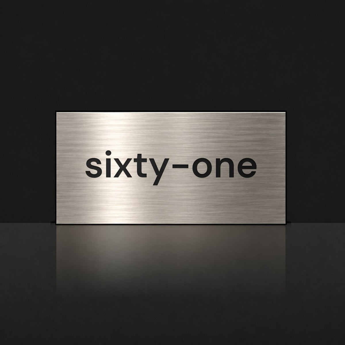 Brushed silver house number sign with a brushed metal look, The Montville, with the number spelled out as sixty-one in black lettering.