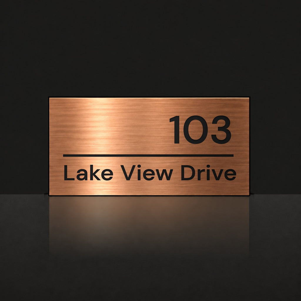 Brushed copper house number and street name sign with a brushed metal look, The Noosa, reading 103 Lake View Drive in black lettering.