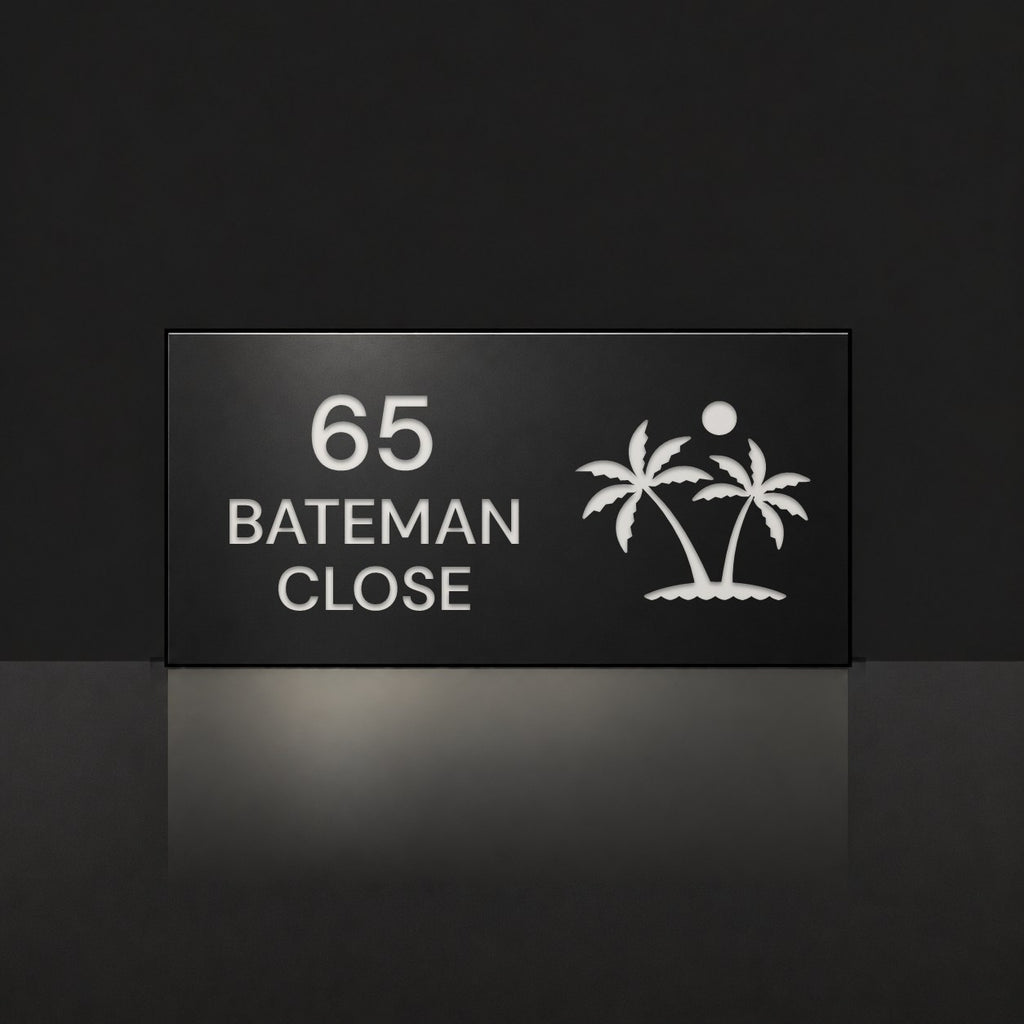 Matte black house number and street name sign, The Yaroomba, reading 65 Bateman Close in white lettering, with palm trees and a sun.