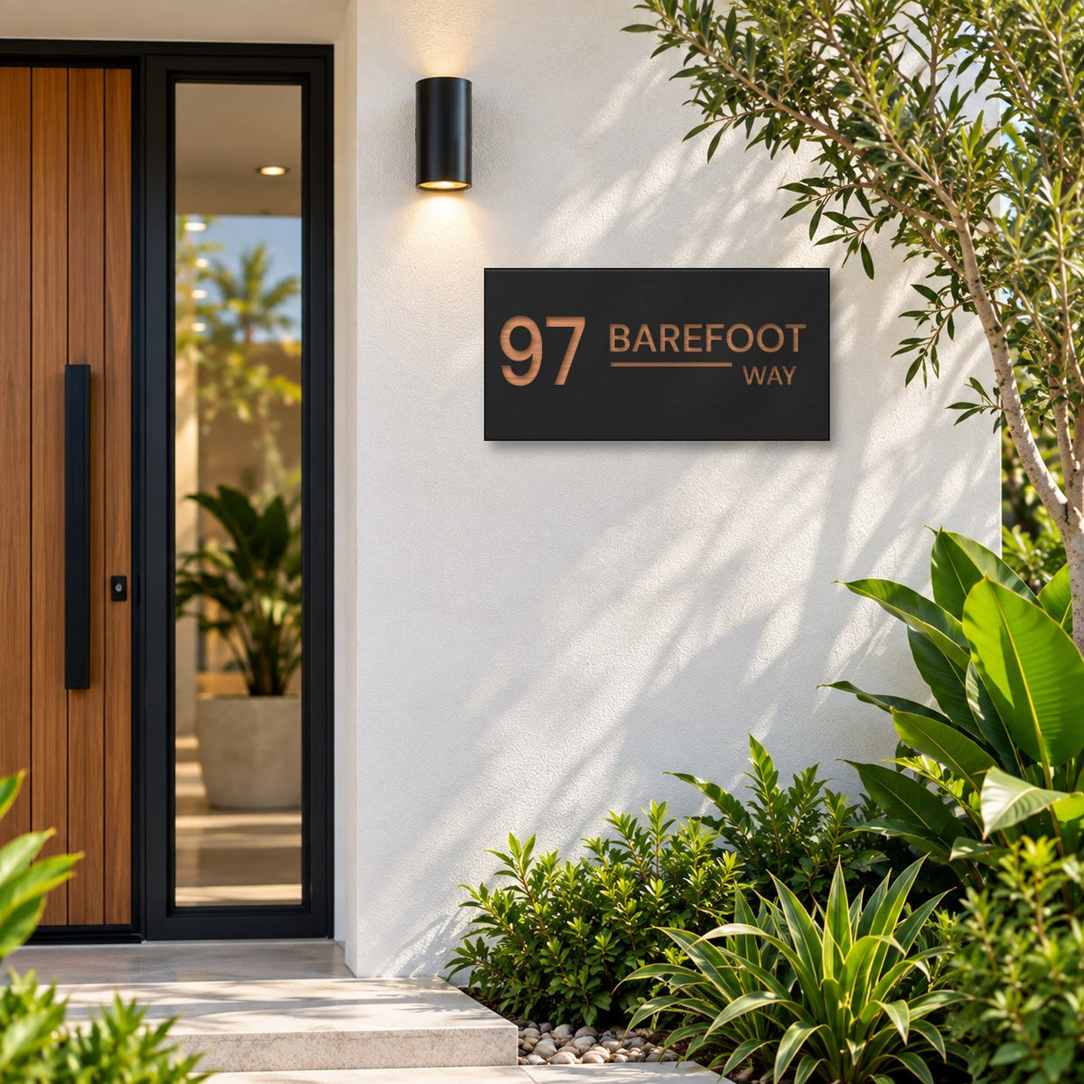 Brushed copper house number and street name sign with a brushed metal look, The Alexandra, black face reading 97 Barefoot Way in copper lettering, mounted on a white rendered wall beside a timber front door.