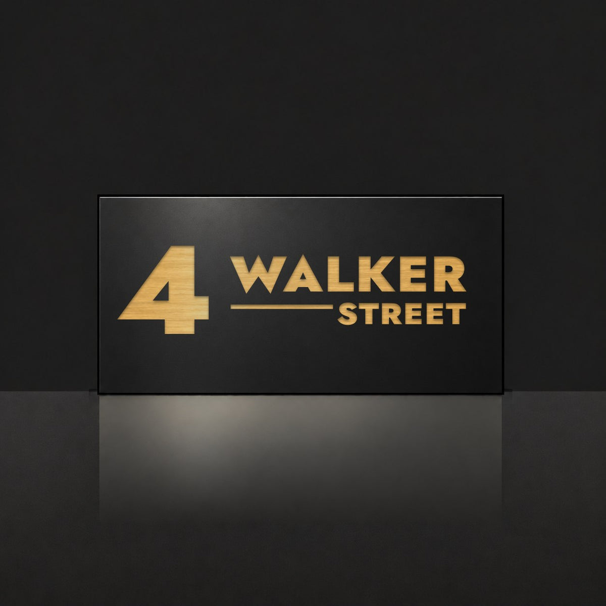 Brushed gold house number and street name sign with a brushed metal look, The Alexandra, black face reading 4 Walker Street in gold lettering.