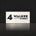 Matte white house number and street name sign, The Alexandra, reading 4 Walker Street in black lettering.