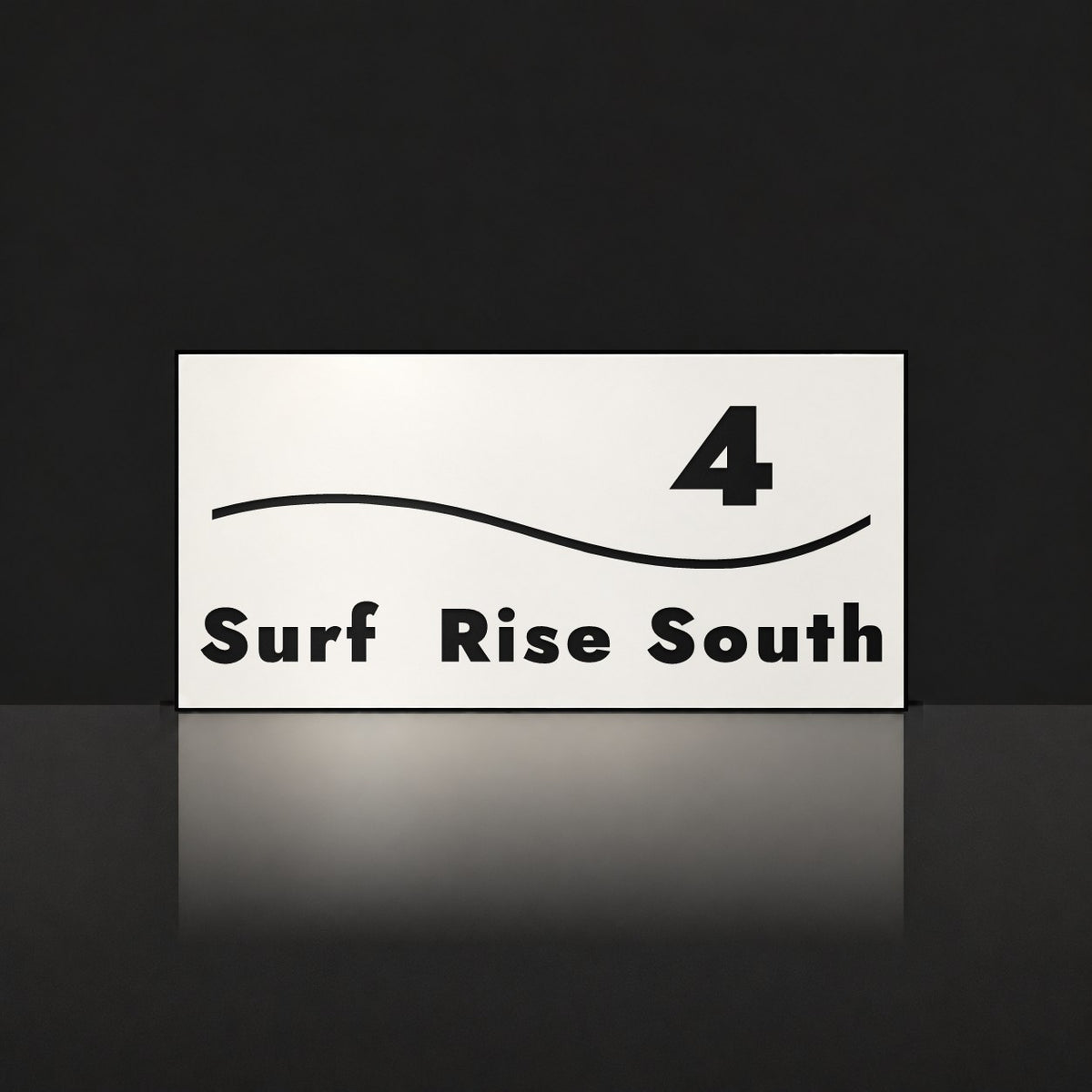 Matte white house number and street name sign, The Bokarina, reading 4 Surf Rise South in black lettering, with a wave line.