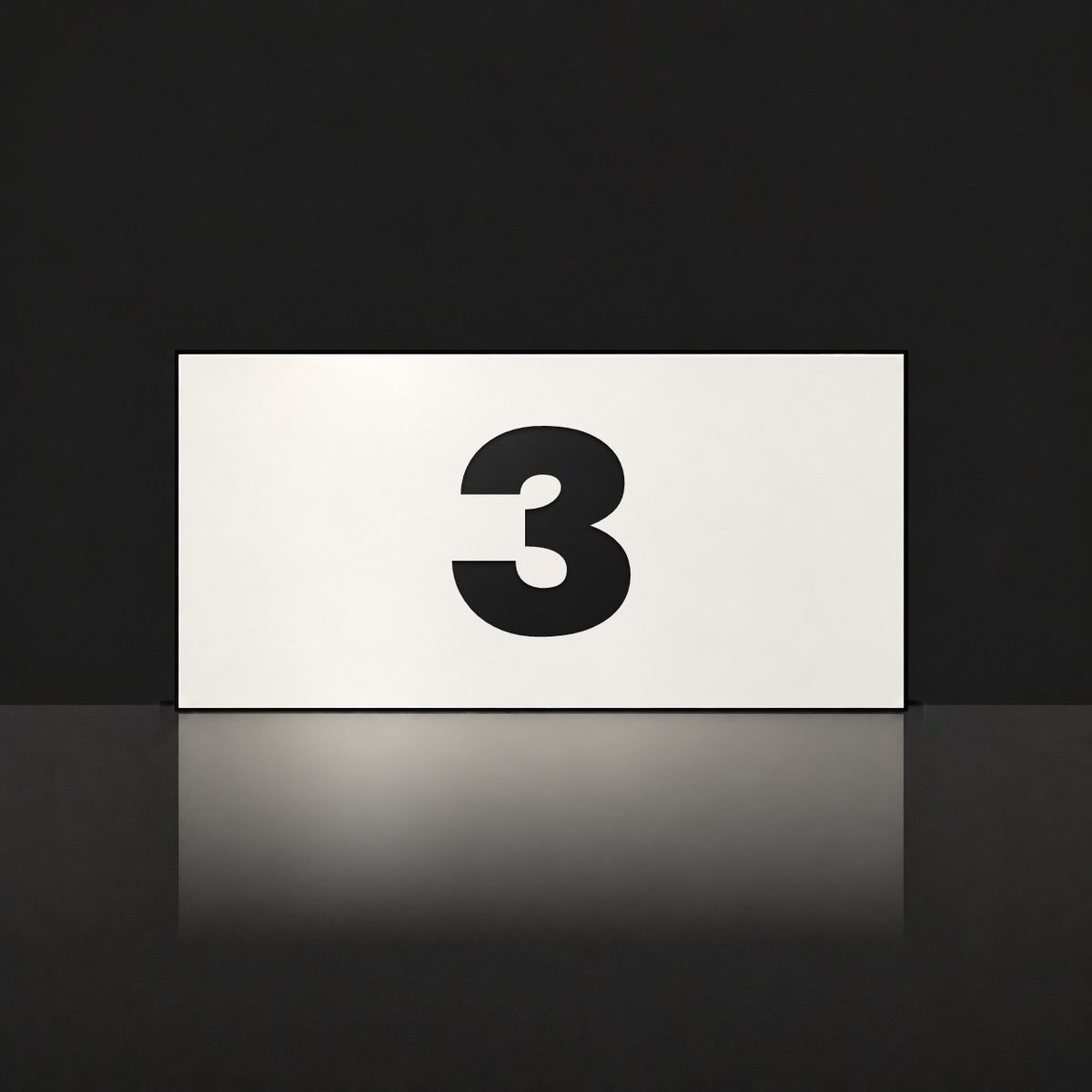 Matte white house number sign, The Kawana, with the number 3 in black lettering.