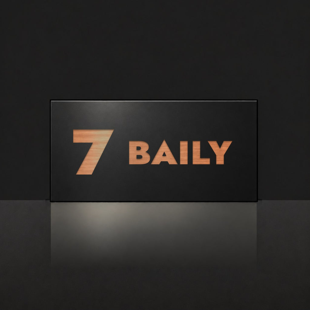 Brushed copper house number and street name sign with a brushed metal look, The Maleny, black face reading 7 Baily in copper lettering.