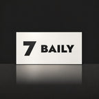 Matte white house number and street name sign, The Maleny, reading 7 Baily in black lettering.