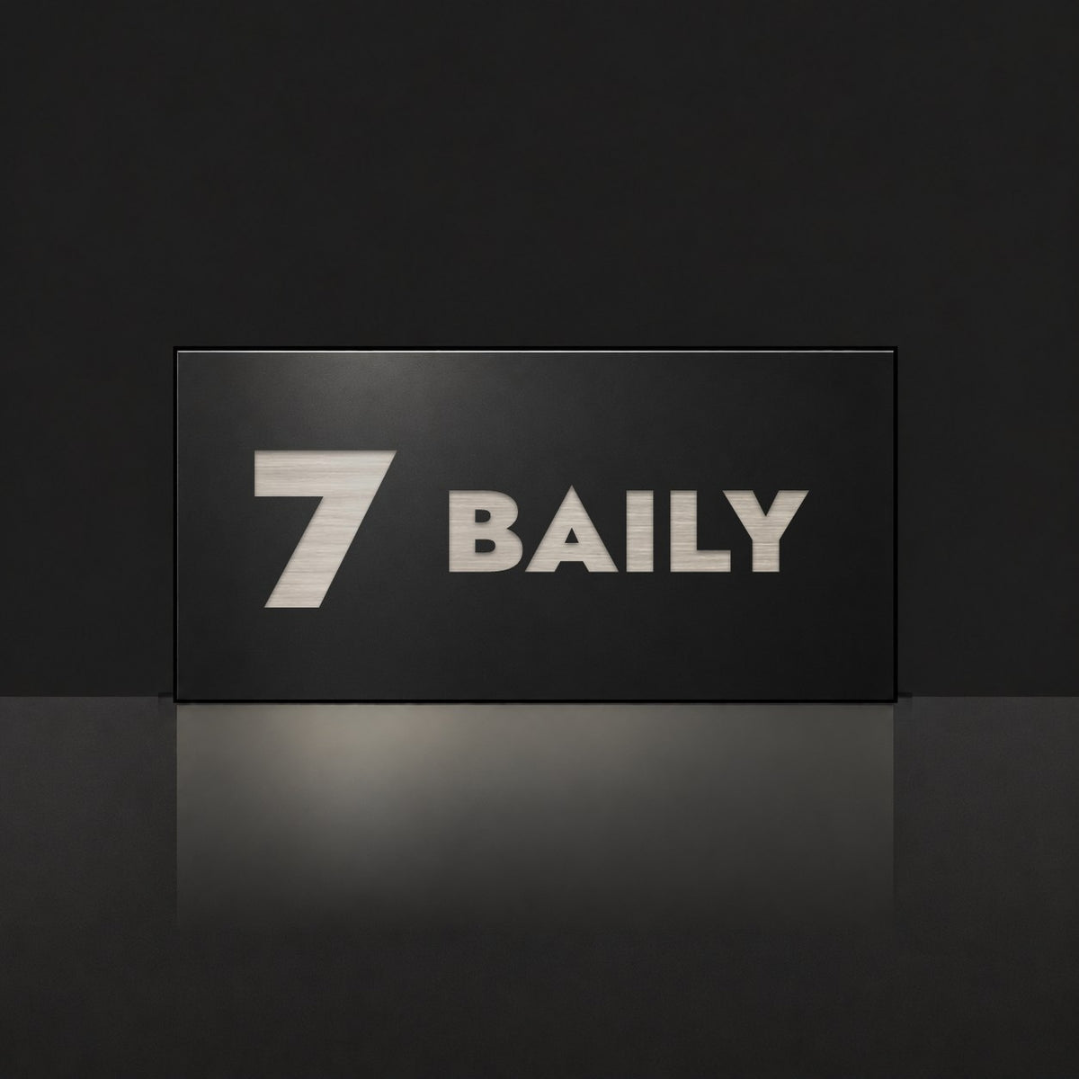 Brushed silver house number and street name sign with a brushed metal look, The Maleny, black face reading 7 Baily in silver lettering.