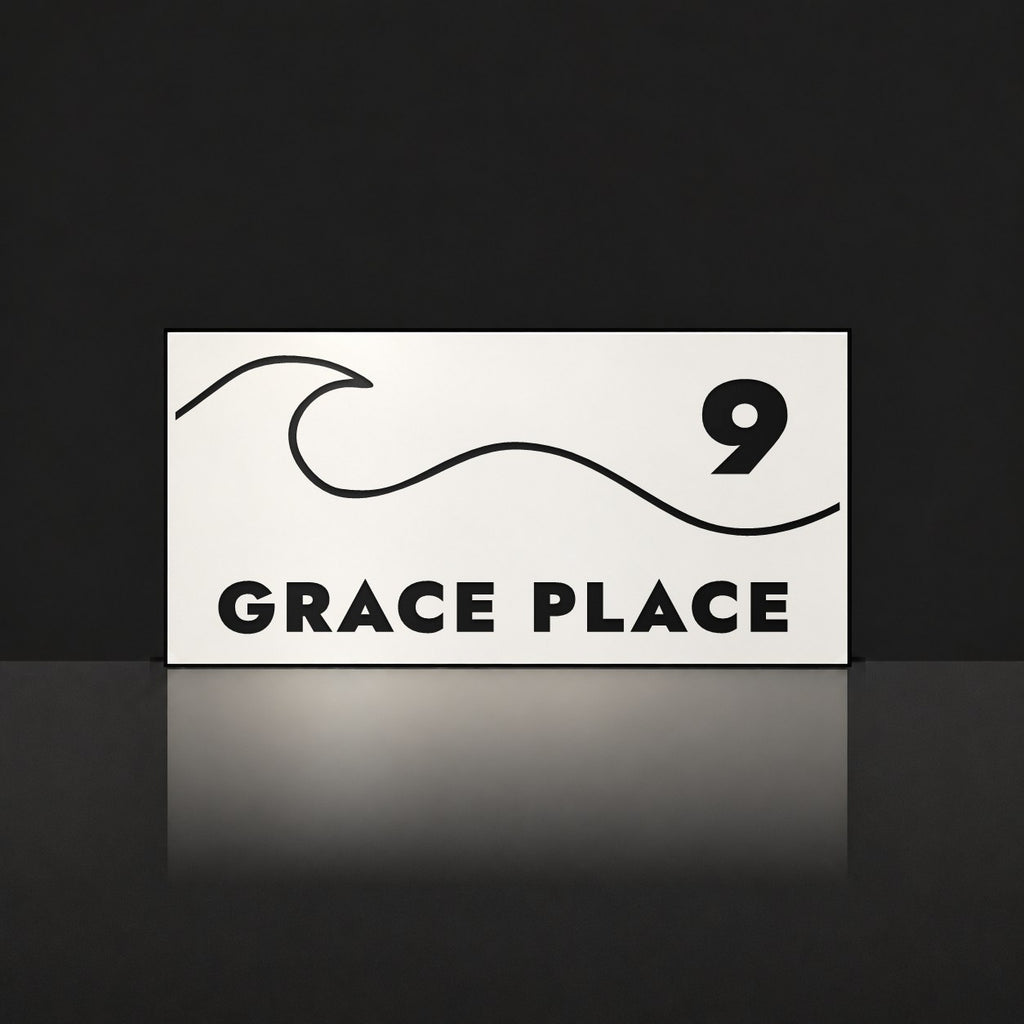Matte white house number and street name sign, The Moffat, reading 9 Grace Place in black lettering, with a wave.