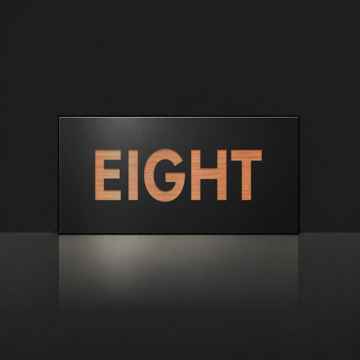 Brushed copper house number sign with a brushed metal look, The Montville, black face with the number spelled out as eight in copper lettering.