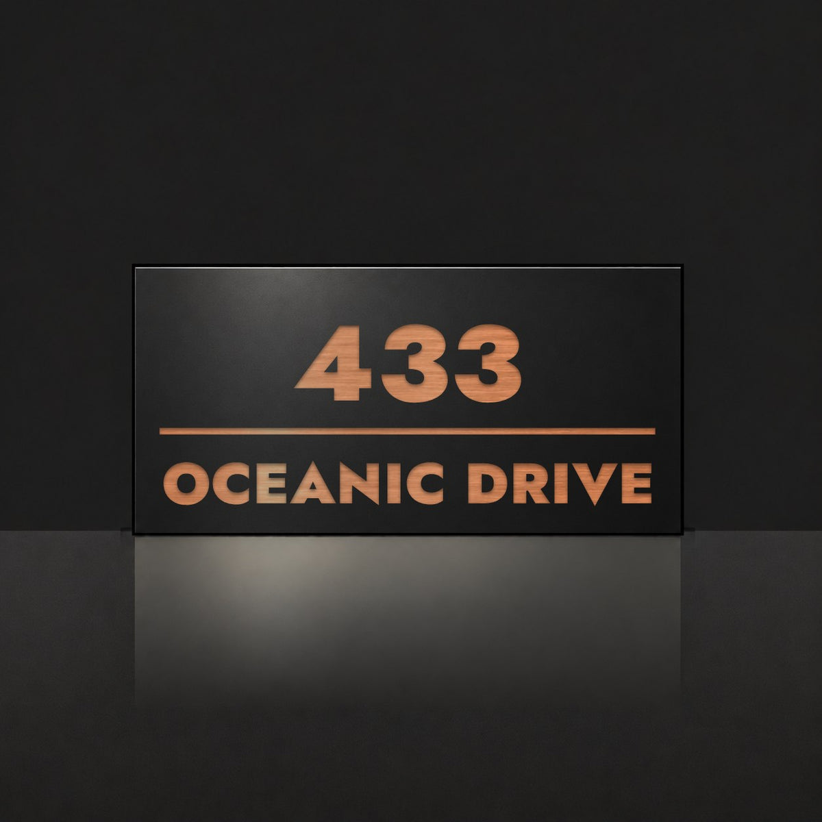 Brushed copper house number and street name sign with a brushed metal look, The Noosa, black face reading 433 Oceanic Drive in copper lettering.