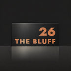 Brushed copper house number and street name sign with a brushed metal look, The Peregian, black face reading 26 The Bluff in copper lettering.