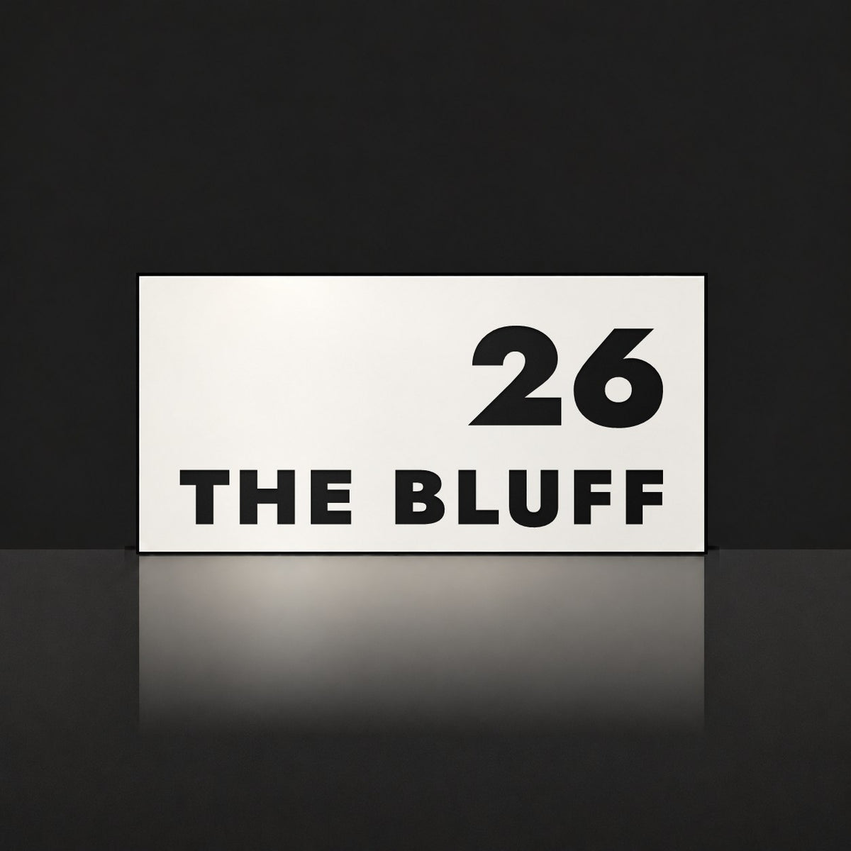 Matte white house number and street name sign, The Peregian, reading 26 The Bluff in black lettering.