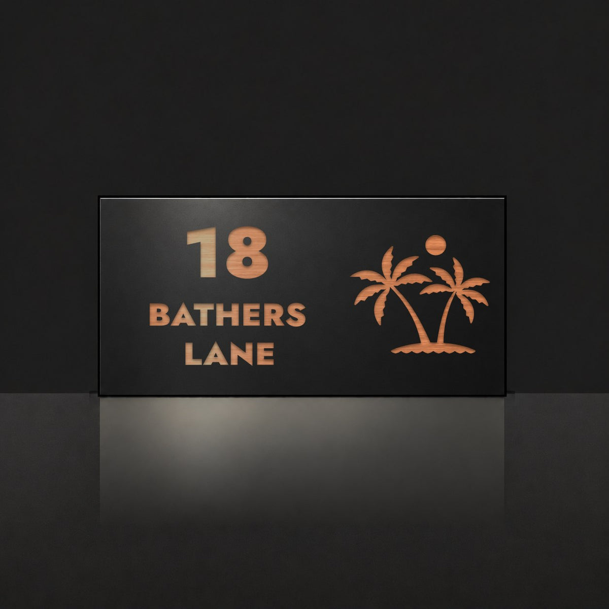 Brushed copper house number and street name sign with a brushed metal look, The Yaroomba, black face reading 18 Bathers Lane in copper lettering, with palm trees and a sun.