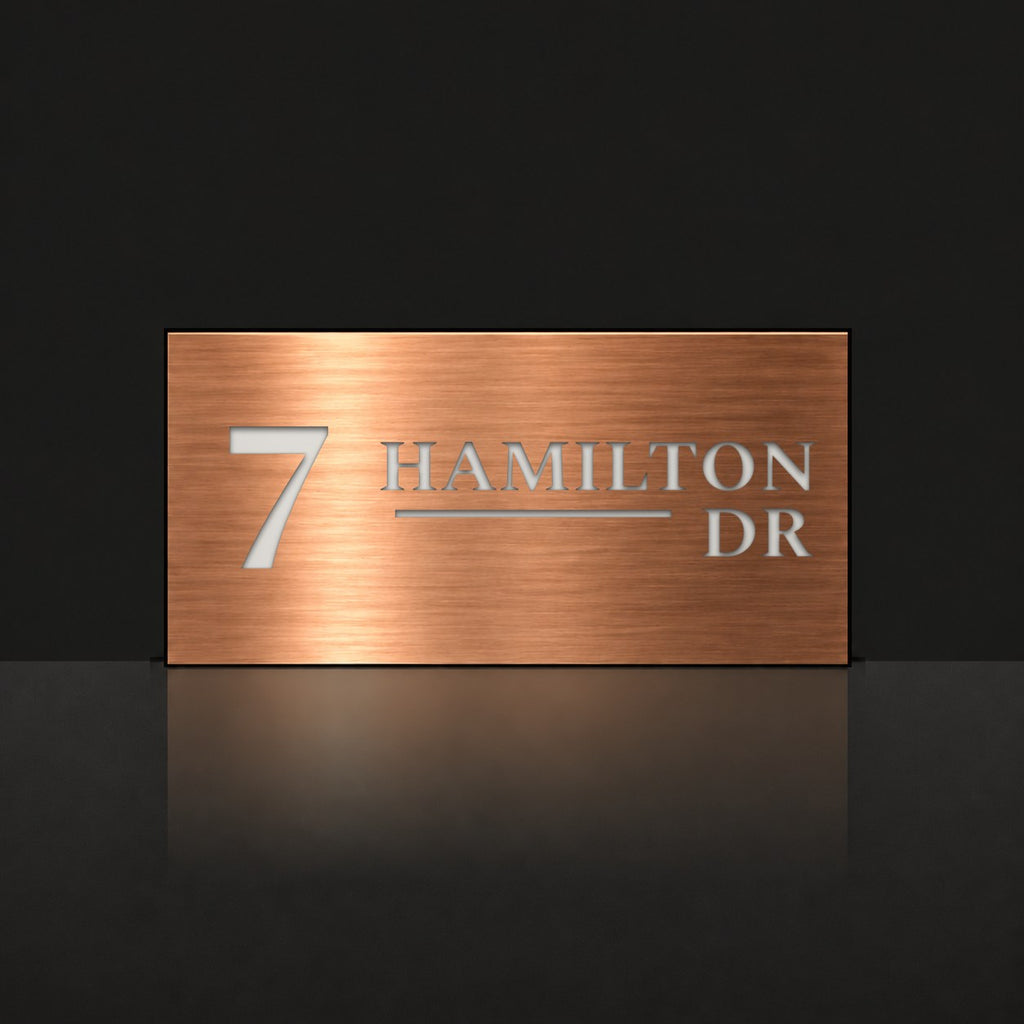 Brushed copper house number and street name sign with a brushed metal look, The Alexandra, reading 7 Hamilton Dr in white lettering.