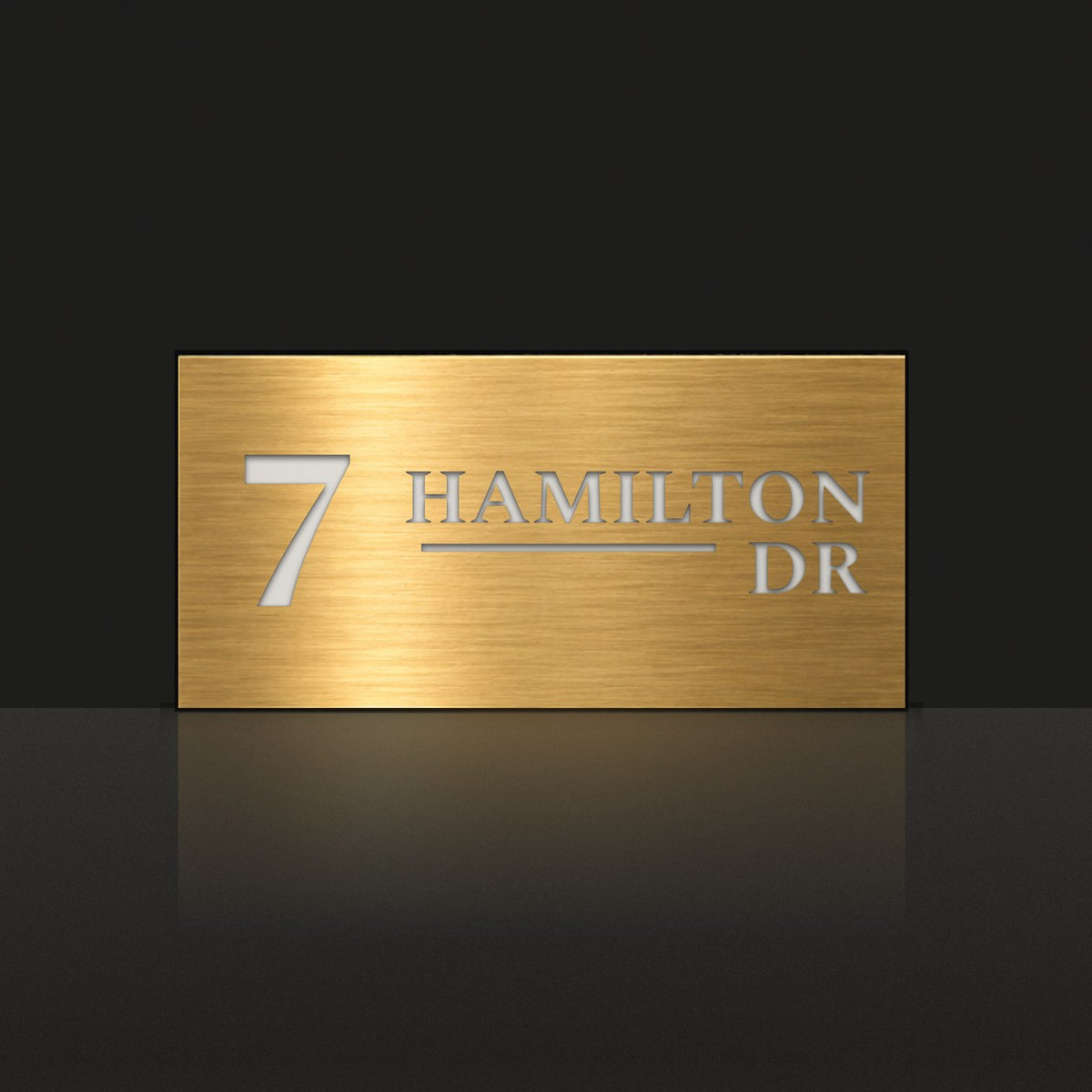 Brushed gold house number and street name sign with a brushed metal look, The Alexandra, reading 7 Hamilton Dr in white lettering.