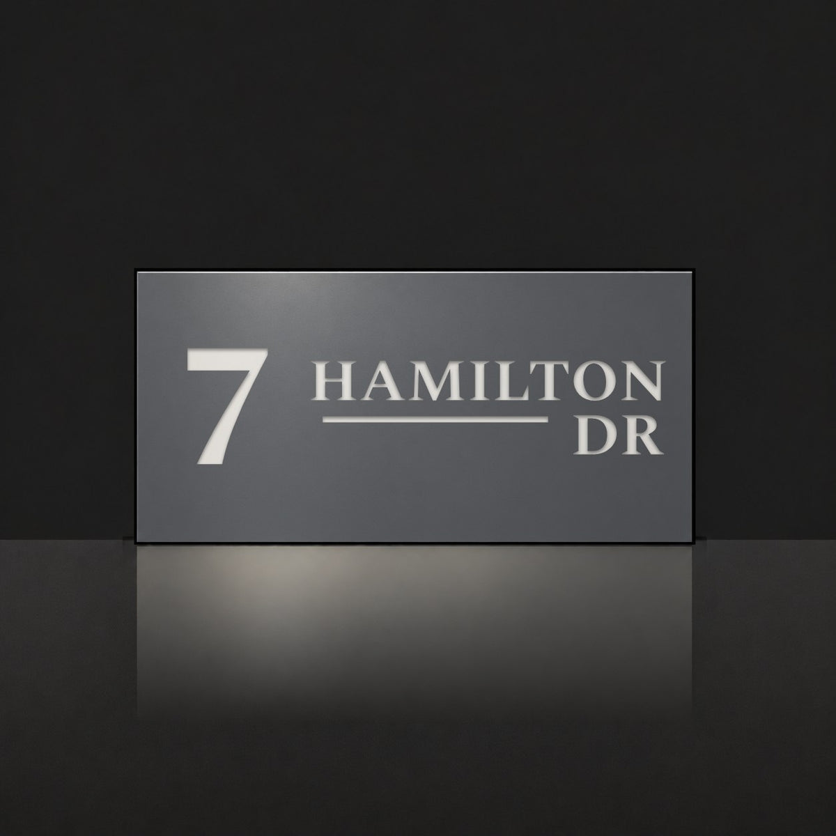 Matte charcoal house number and street name sign, The Alexandra, reading 7 Hamilton Dr in white lettering.