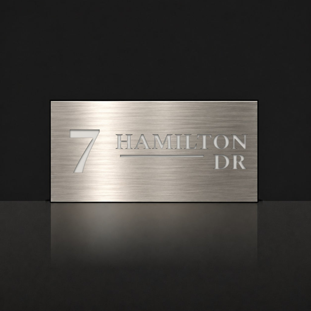 Brushed silver house number and street name sign with a brushed metal look, The Alexandra, reading 7 Hamilton Dr in white lettering.