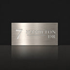 Brushed silver house number and street name sign with a brushed metal look, The Alexandra, reading 7 Hamilton Dr in white lettering.