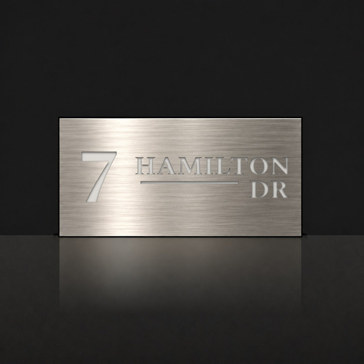 Brushed silver house number and street name sign with a brushed metal look, The Alexandra, reading 7 Hamilton Dr in white lettering.