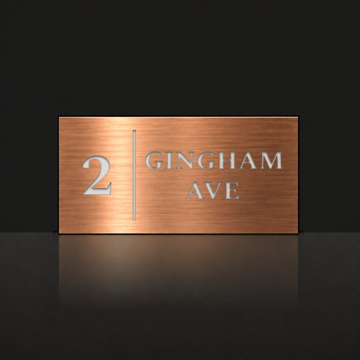 Brushed copper house number and street name sign with a brushed metal look, The Coolum, reading 2 Gingham Ave in white lettering, with a dividing line.