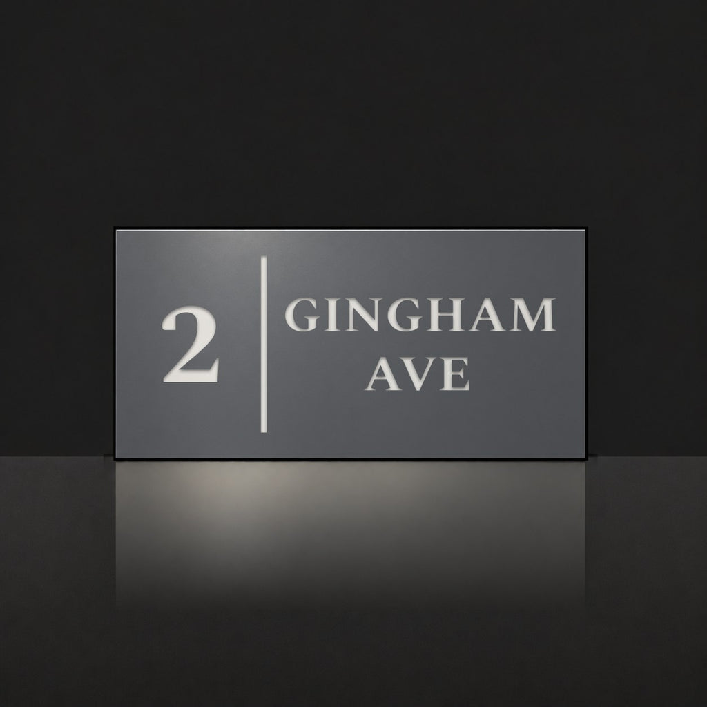 Matte charcoal house number and street name sign, The Coolum, reading 2 Gingham Ave in white lettering, with a dividing line.