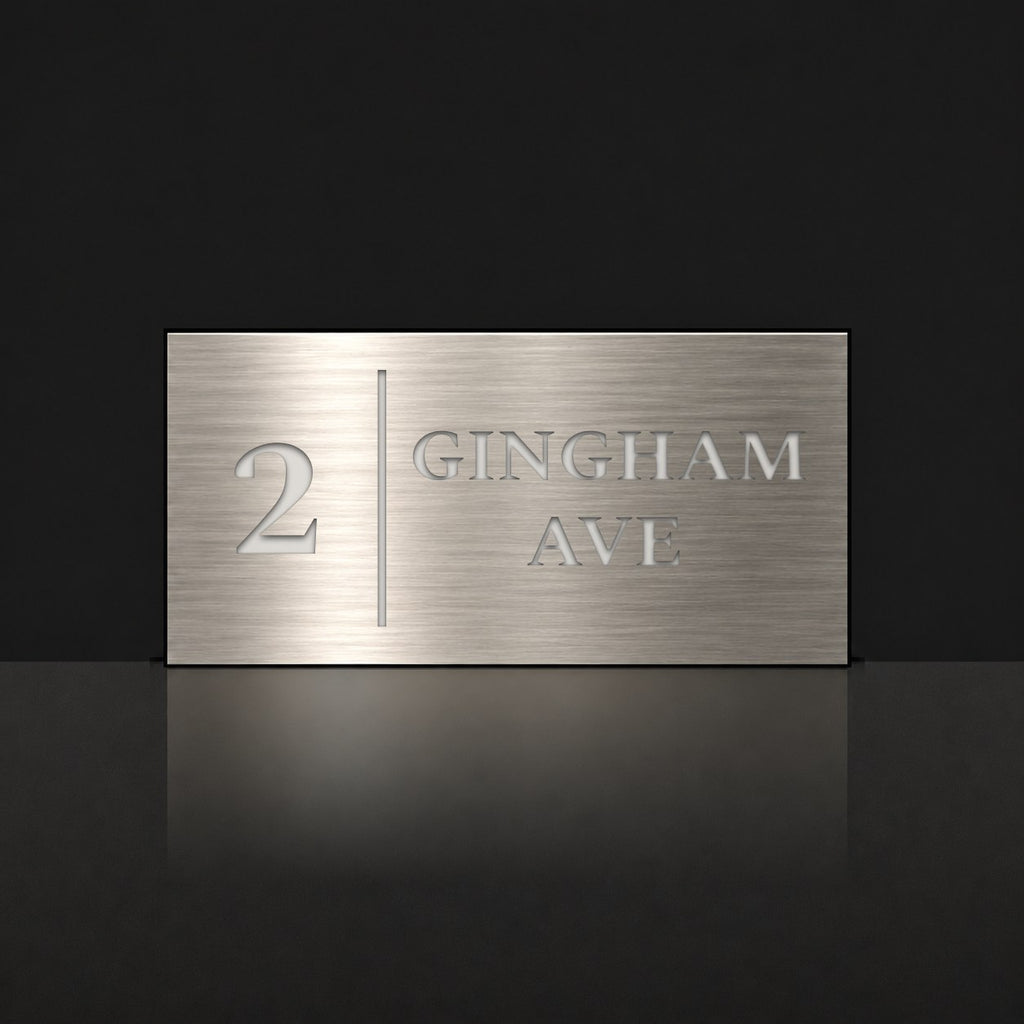 Brushed silver house number and street name sign with a brushed metal look, The Coolum, reading 2 Gingham Ave in white lettering, with a dividing line.