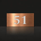 Brushed copper house number sign with a brushed metal look, The Kawana, with the number 51 in white lettering.