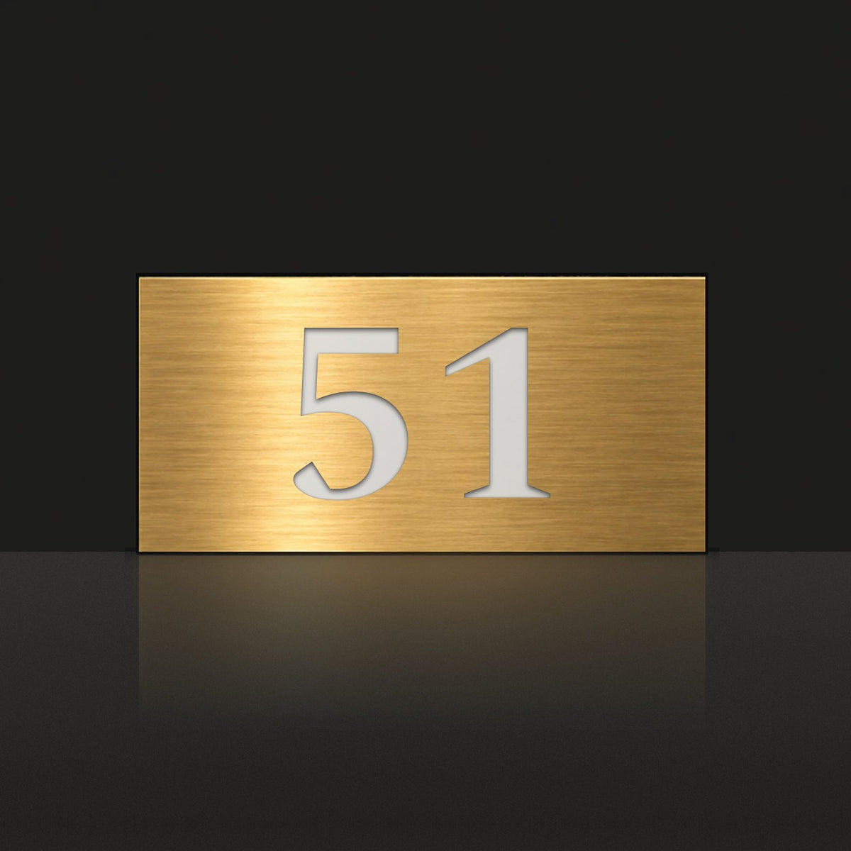 Brushed gold house number sign with a brushed metal look, The Kawana, with the number 51 in white lettering.