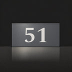 Matte charcoal house number sign, The Kawana, with the number 51 in white lettering.