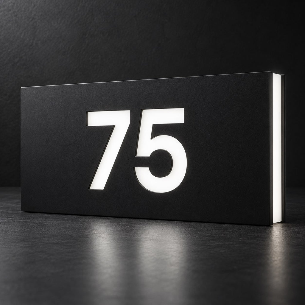 Matte black illuminated house number sign, The Kawana, displaying 75 in glowing white on a dark background.