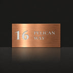 Brushed copper house number and street name sign with a brushed metal look, The Maleny, reading 16 Pelican Way in white lettering.