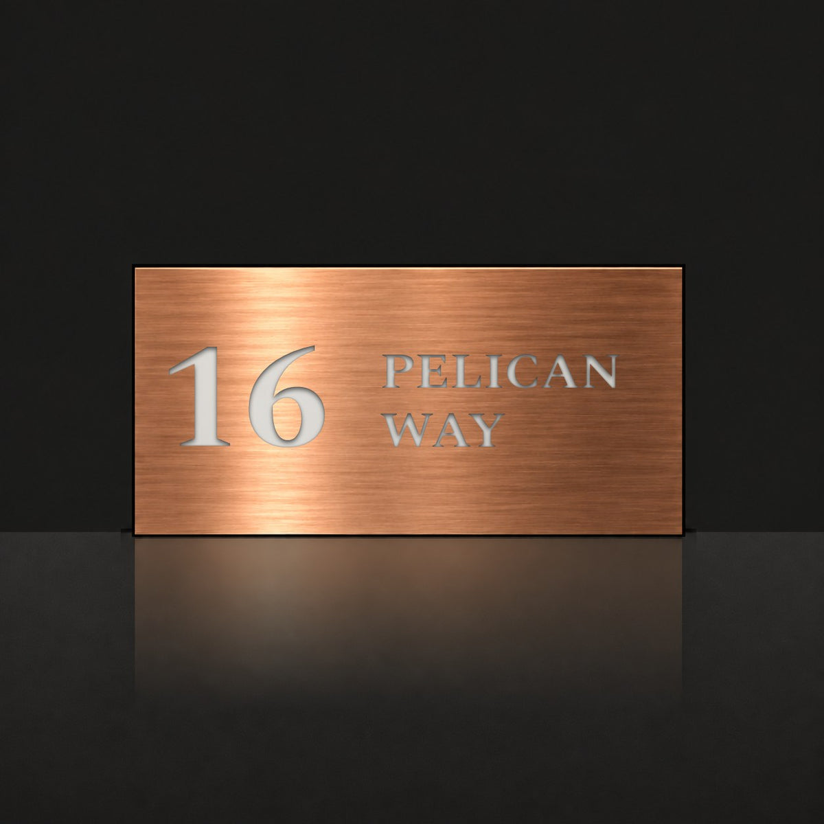 Brushed copper house number and street name sign with a brushed metal look, The Maleny, reading 16 Pelican Way in white lettering.